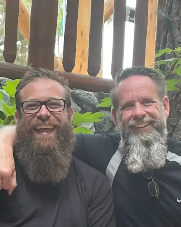 Mark standing side-by-side with his brother John